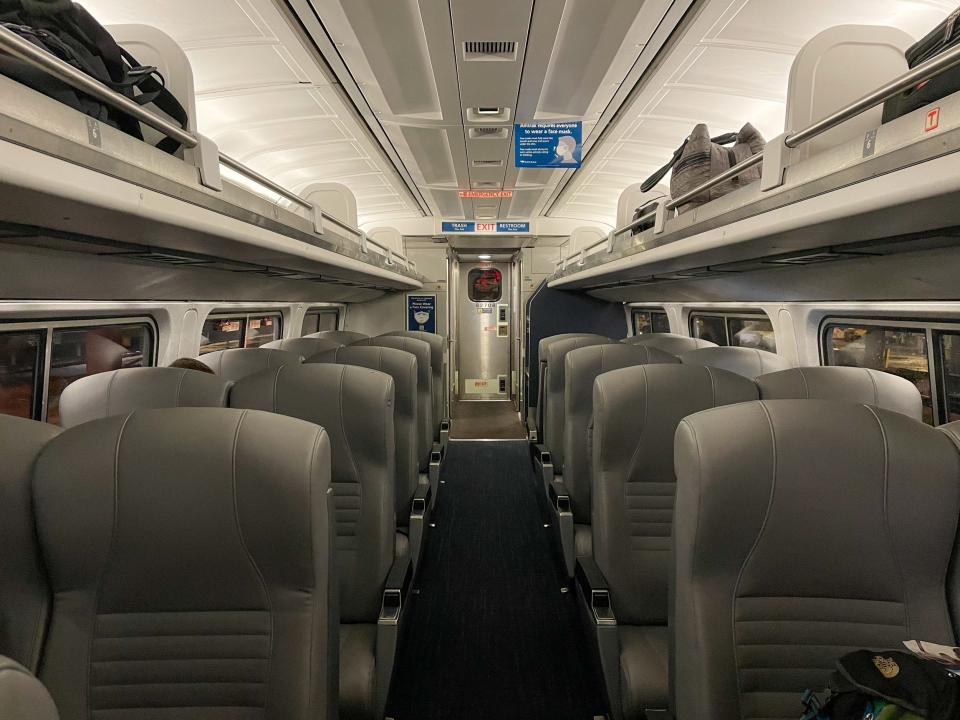 Rows of empty passenger seats. Many are empty.