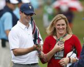 Zach Johnson of the U.S. and his wife Kim Barclay react after he won his match against Branden Grace of South Africa during the Singles matches for the 2013 Presidents Cup golf tournament at Muirfield Village Golf Club in Dublin, Ohio October 6, 2013. REUTERS/Chris Keane (UNITED STATES - Tags: SPORT GOLF)