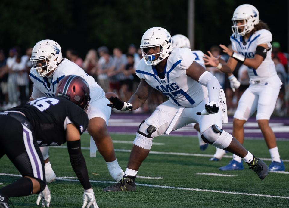 IMG's Jordan Seaton (77) protects his quarterback against a Lipscomb defender at Lipscomb's Reese Smith Football Field in Nashville, Tenn., Friday night, Aug. 18, 2023. IMG went on to win the game 35-10.