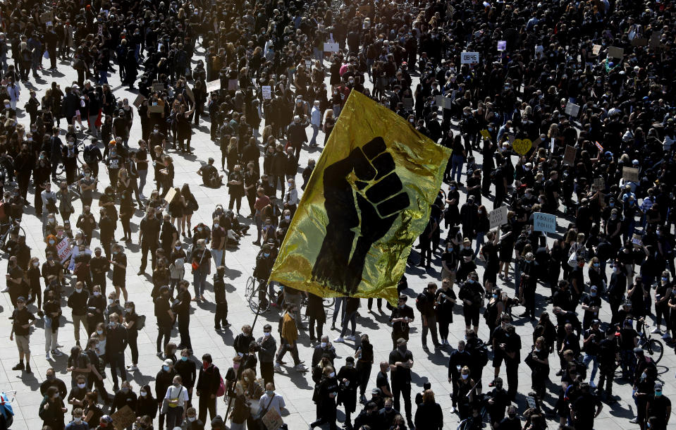 People gather in Berlin, Germany, Saturday, June 6, 2020, to protest against the recent killing of George Floyd by police officers in Minneapolis, USA, that has led to protests in many countries and across the US. A US police officer has been charged with the death of George Floyd. (AP Photo/Markus Schreiber)