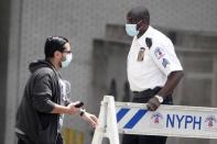 A guard prevents access to a street outside the New York Presbyterian Hospital where U.S. President Donald Trump's brother Robert has been admitted