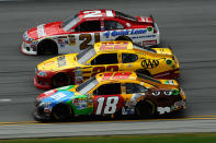 TALLADEGA, AL - MAY 06: Kyle Busch, driver of the #18 M&M's Toyota, AJ Allmendinger, driver of the #22 Shell/Pennzoil-AAA Dodge, and Trevor Bayne, driver of the #21 Motorcraft/Quick Lane Tire & Auto Center Ford, race during the NASCAR Sprint Cup Series Aaron's 499 at Talladega Superspeedway on May 6, 2012 in Talladega, Alabama. (Photo by Jared C. Tilton/Getty Images)