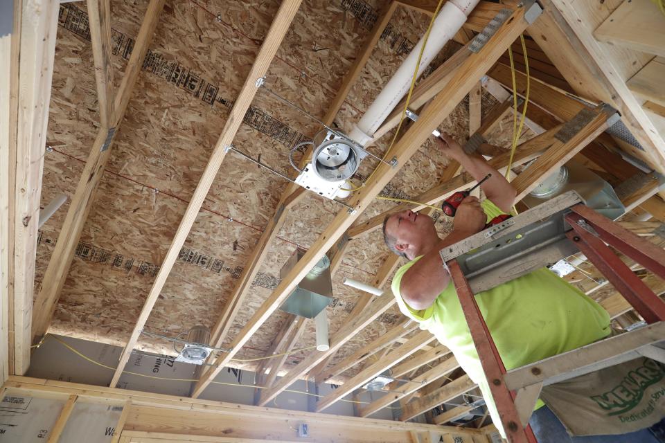 Mark Schiefelbein, an employee with Condon Total Comfort, Inc., installs heating vents in a laundry room of the community center Tuesday at the Oshkosh Kids Foundation's Tiny Homes Village on the 200 block of West Packer Ave. The village will house up to 31 homeless individuals and families once it is completed in spring. Up to 16 families could be moved in by this winter.