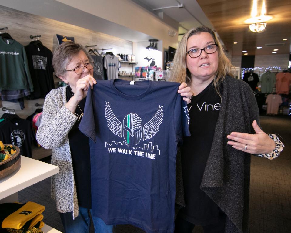 Michelle Kozyra Letendre, with her mom Betty Kozyra, shown Wednesday, Nov. 3, 2021, talks about a special T-shirt she produced through her downtown Brighton business Ivory Vines for a participant in the "Ruck to Live Walk" in September.