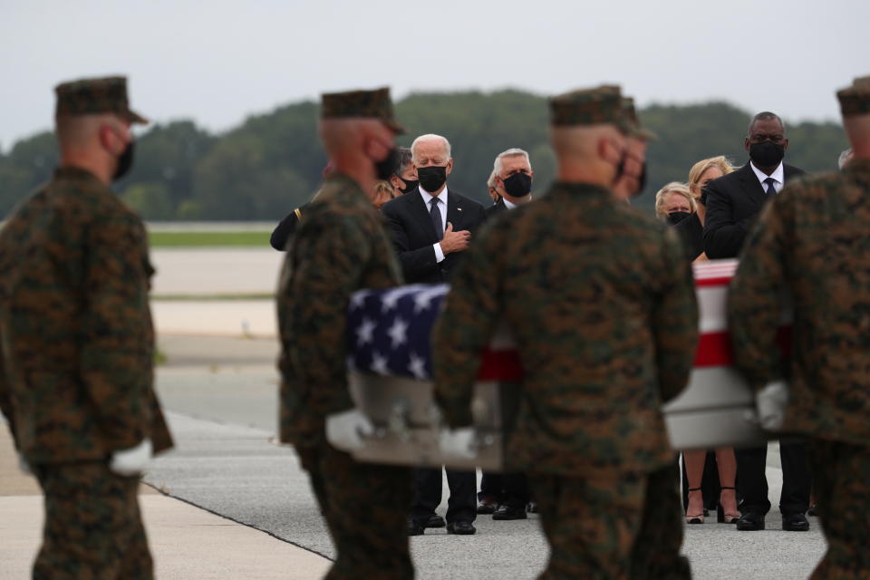 U.S. President Joe Biden salutes during the dignified transfer of the remains of U.S. Military service members who were killed by a suicide bombing at the Hamid Karzai International Airport, at Dover Air Force Base in Dover, Delaware, U.S., August 29, 2021. REUTERS/Tom Brenner