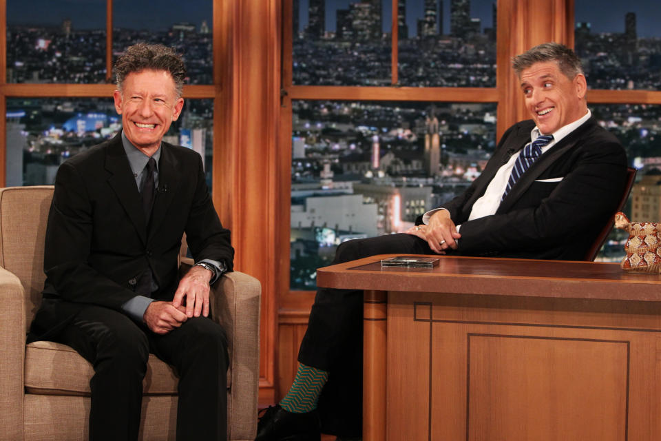 This Wednesday, April 23, 2014 photo released by CBS shows Lyle Lovett, left, and Craig Ferguson on "The Late Late Show with Craig Ferguson," on the CBS Television Network. Ferguson says he is stepping down as host of the show this year. CBS said that Ferguson made the announcement to his studio audience Monday, April 28, 2014. (AP Photo/CBS, Sonja Flemming) MANDATORY CREDIT, NO ARCHIVE, NO SALES, FOR NORTH AMERICAN USE ONLY