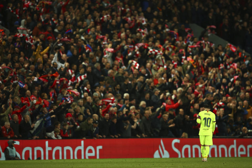 Barcelona's Lionel Messi walks as Liverpool's Divock Origi celebrates scoring his side's 4th goal during the Champions League semifinal, second leg, soccer match between Liverpool and FC Barcelona at the Anfield stadium in Liverpool, England, Tuesday, May 7, 2019. (AP Photo/Dave Thompson)