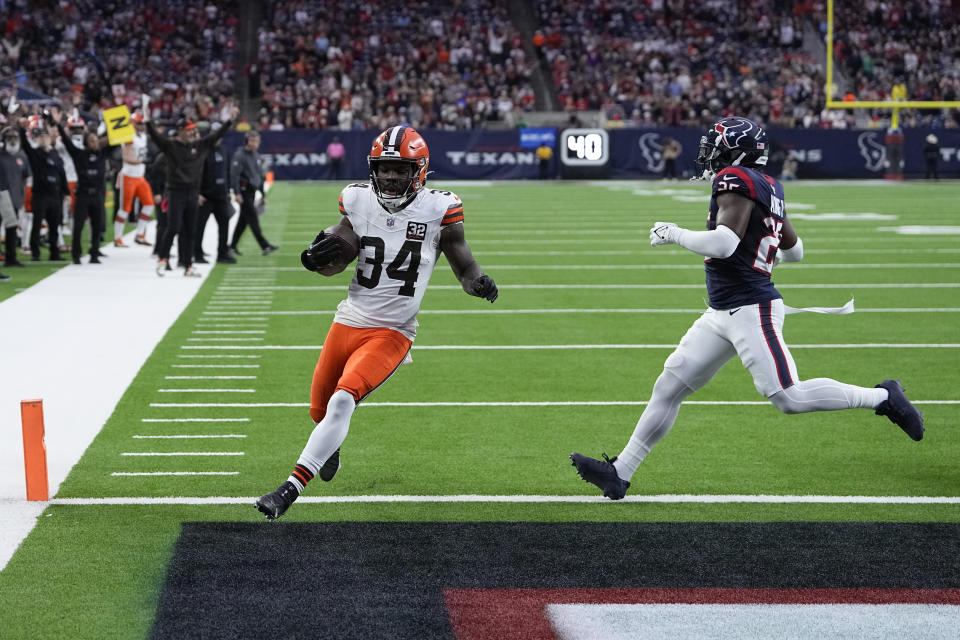 Cleveland Browns running back Jerome Ford (34) scores a touchdown as Houston Texans cornerback Desmond King II (25) defends during the first half of an NFL football game Sunday, Dec. 24, 2023, in Houston. (AP Photo/David J. Phillip)