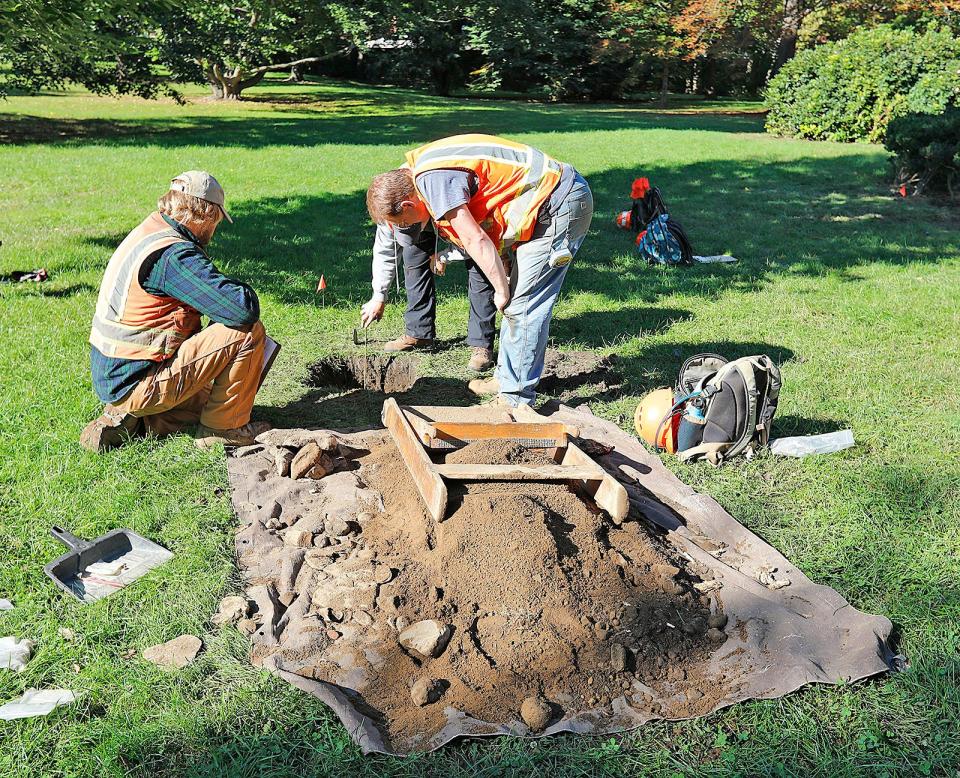 From left, Andrew Polta, Jennifer Banister and John Kelly look at a test hole at the Dorothy Quincy Homestead in Quincy on Wednesday, Sept. 29, 2021.