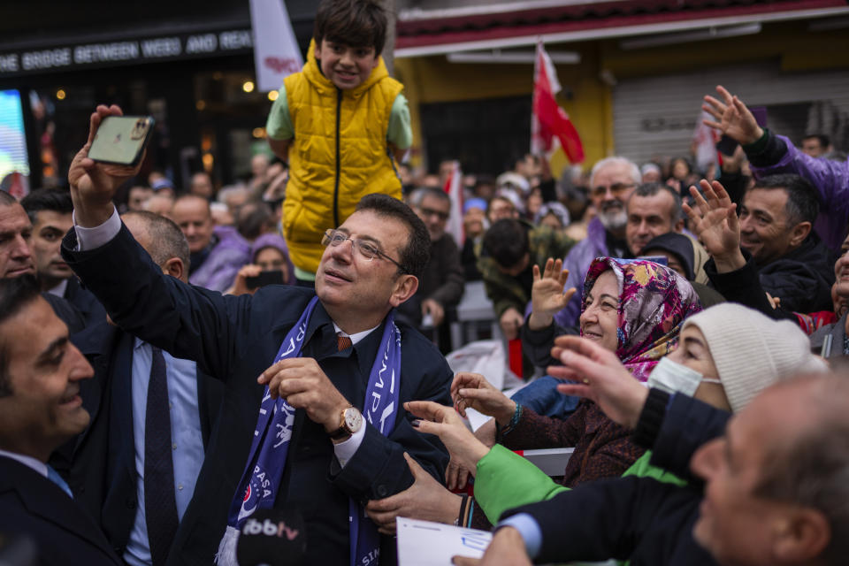Istanbul Mayor and Republican People's Party, or CHP, candidate Ekrem Imamoglu take photographs with supporters during a campaign rally in Istanbul, Turkey, Thursday, March 21, 2024. Turkey was coming to terms on Monday with the opposition's unexpected success in local elections which saw it outperform President Recep Tayyip Erdogan's ruling party and add to municipalities gained five years ago. (AP Photo/Francisco Seco)