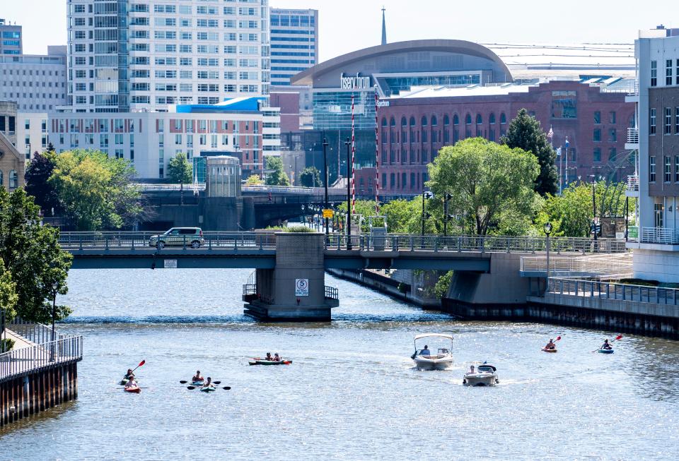 People enjoy the hot weather by being on boats on Friday, July 22, 2022 on the Milwaukee River in Milwaukee, Wis.