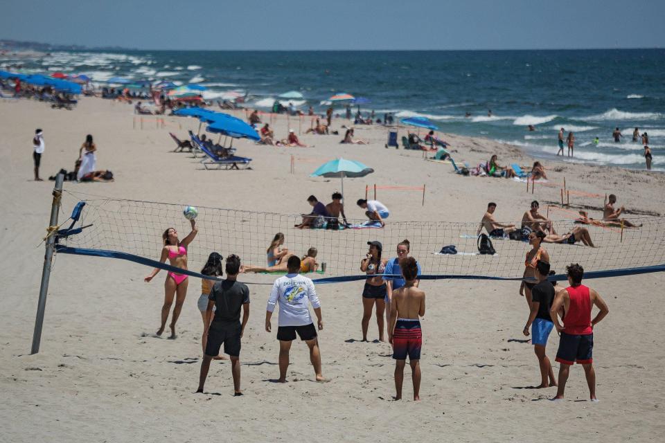 Beachgoers play sports, surf and sunbathe on the beachfront in Boca Raton on Friday, June 12, 2020. Skies should be clear for Saturday but expect heavy rains into next week.