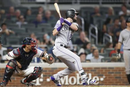 Aug 16, 2018; Atlanta, GA, USA; Colorado Rockies left fielder David Dahl (26) hits a two-RBI single against the Atlanta Braves in the ninth inning at SunTrust Park. Brett Davis-USA TODAY Sports