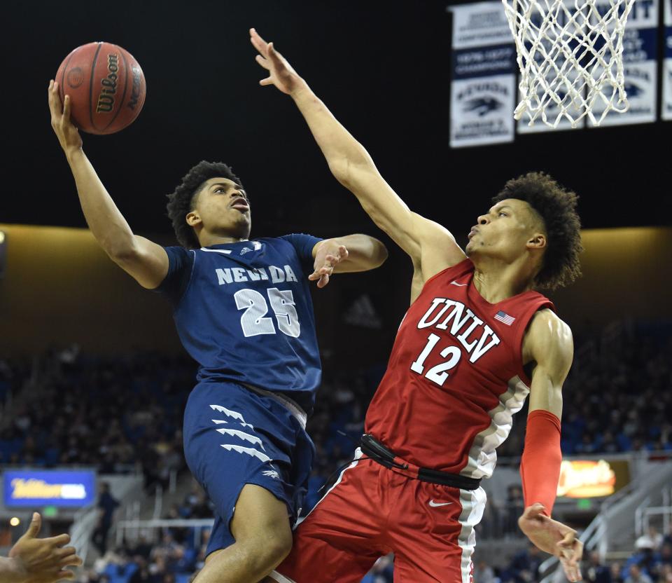 Former Nevada standout Grant Sherfield, left, shoots against UNLV's David Mouka in February. Sherfield has transferred to OU and will be eligible for the 2022-23 season.