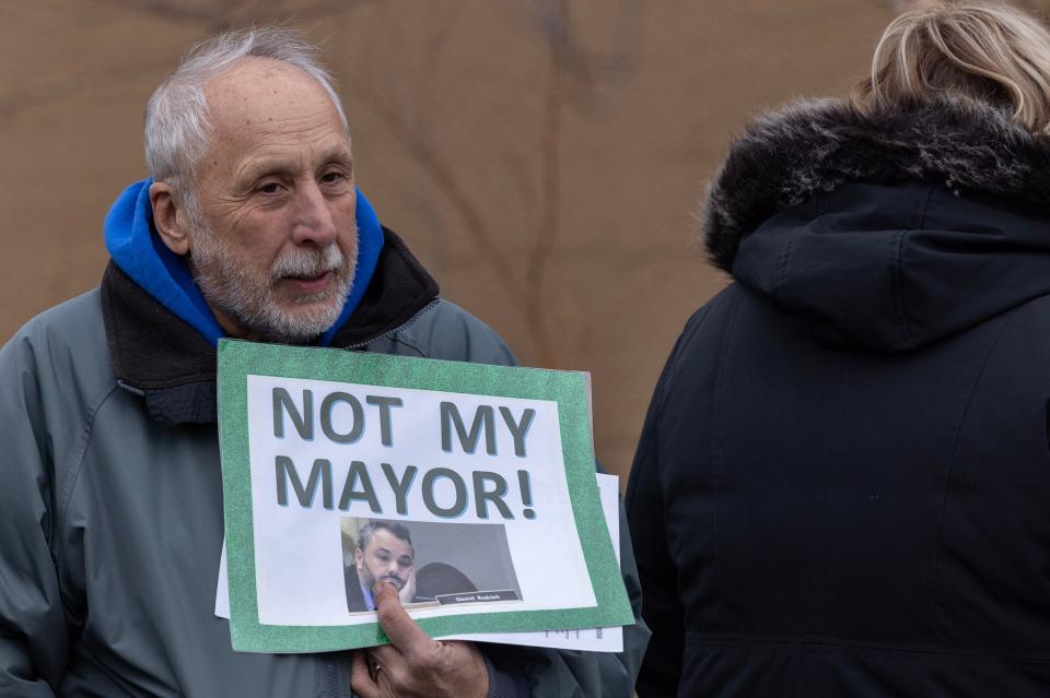 Jerry Nappi holds a sign criticizing Mayor Daniel Rodrick, whom he voted for in November. Between 80 and 90 people came out to a protest a proposed ordinance on the agenda for January 31 Township Council meeting that would eliminate two police captains jobs. During rally they were collecting signatures in an effort to invalidate the ordinance.