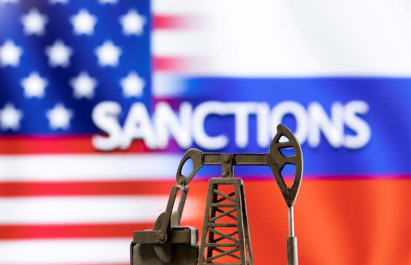 FILE PHOTO: Illustration shows pump jack in the front word "Sanctions", U.S. and Russia flag colours