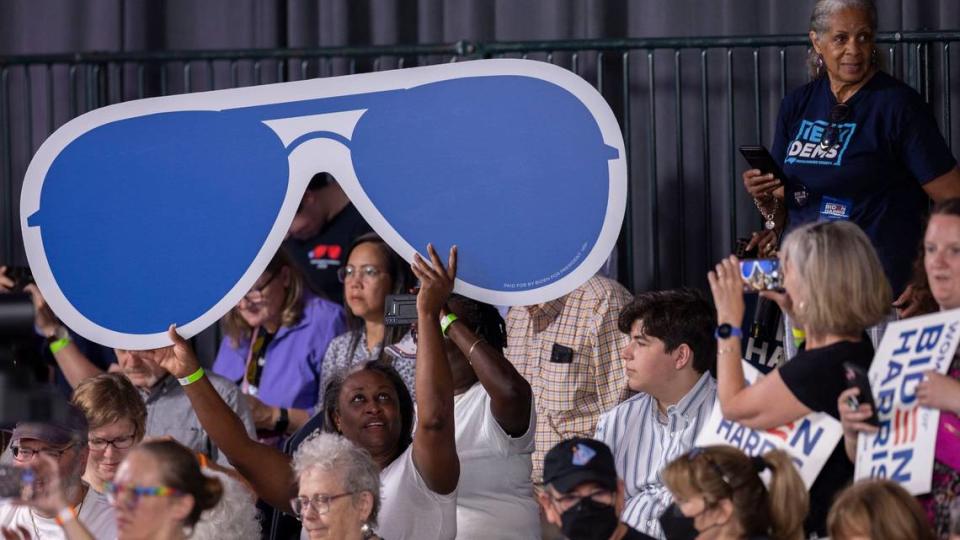 A President Joe Biden supporter holds a sign in the likeness of Biden’s signature aviator sunglasses during a campaign event at the Jim Graham building at the North Carolina State Fairgrounds in Raleigh on Friday June 28, 2024. Biden debated former President Trump in Atlanta Georgia the previous night.