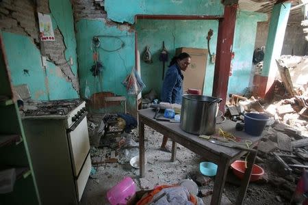 A woman stands inside her damaged home after an earthquake struck the southern coast of Mexico late on Thursday, in Union Hidalgo, Mexico September 9, 2017. REUTERS/Jorge Luis Plata