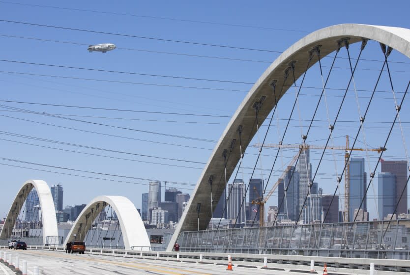 LOS ANGELES, CA - July 19: A blimp flies around downtown for the upcoming All-Star game at Dodger Stadium as seen from the 6th Street Viaduct on Tuesday, July 19, 2022 in Los Angeles, CA. (Myung J. Chun / Los Angeles Times)