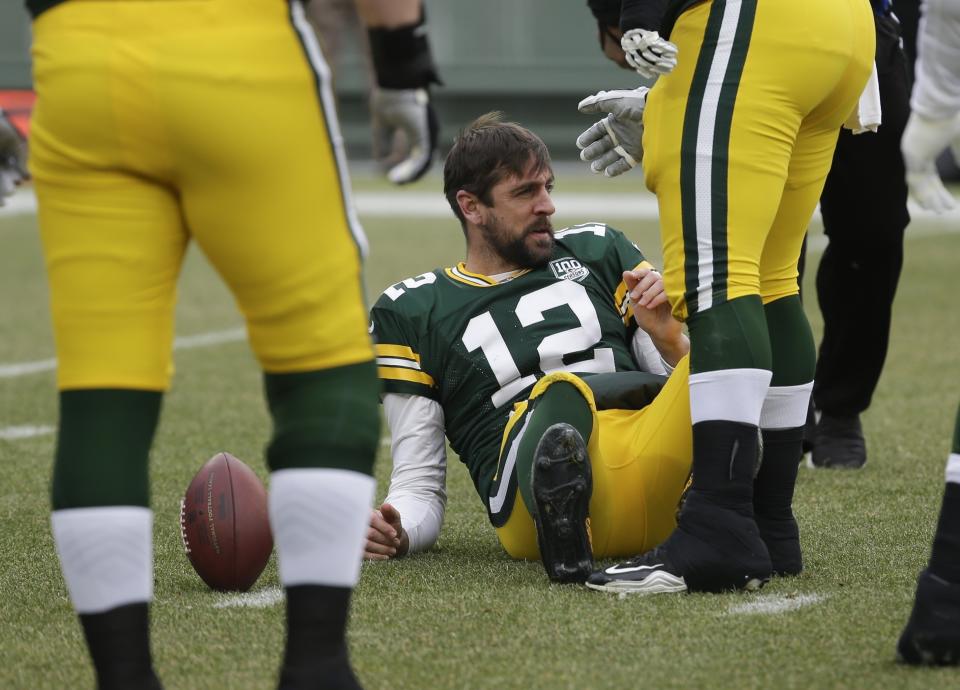 CORRECTS TO REMOVE SCORE- Green Bay Packers' Aaron Rodgers loses his helmet after being sacked during the first half of an NFL football game against the Detroit Lions Sunday, Dec. 30, 2018, in Green Bay, Wis. (AP Photo/Mike Roemer)