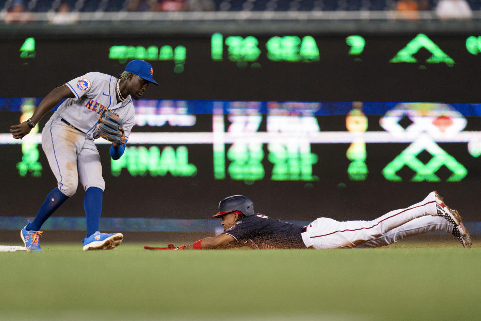 Washington Nationals shortstop CJ Abrams, right, steals second base in front of New York Mets second baseman Ronny Mauricio during the third inning of a baseball game, Wednesday, Sept. 6, 2023, in Washington. (AP Photo/Stephanie Scarbrough)