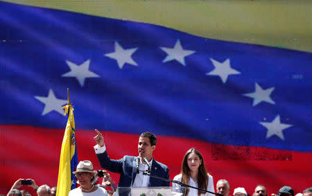 Venezuelan opposition leader Juan Guaido, who many nations have recognized as the country's rightful interim ruler, speaks next to his mother Norka Marquez and his wife Fabiana Rosales, as he attends a rally to commemorate the Day of the Youth and to protest against Venezuelan President Nicolas Maduro's government in Caracas, Venezuela February 12, 2019. REUTERS/Carlos Garcia Rawlins