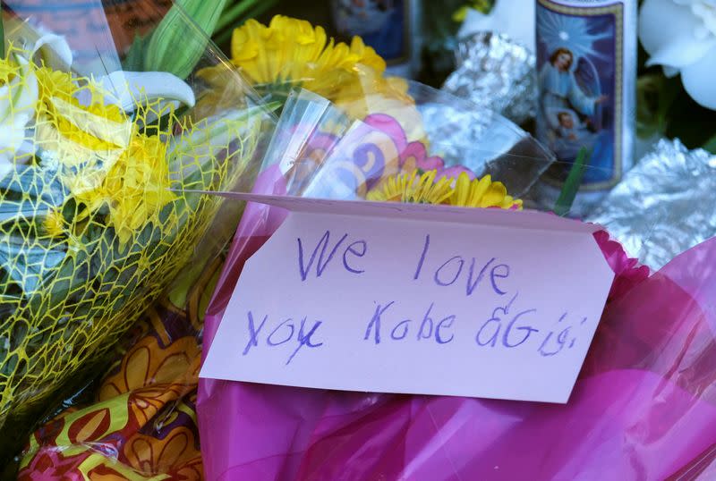 Flowers, photos and messages are placed at a makeshift memorial for former NBA player Kobe Bryant outside of the Mamba Sports Academy in Thousand Oaks