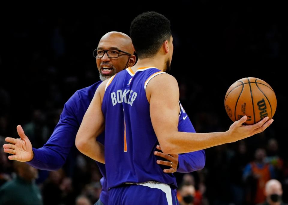November 6, 2021; Phoenix, USA; Suns' head coach Monty Williams greets Devin Booker (1) after a timeout during the second half at the Footprint Center.
