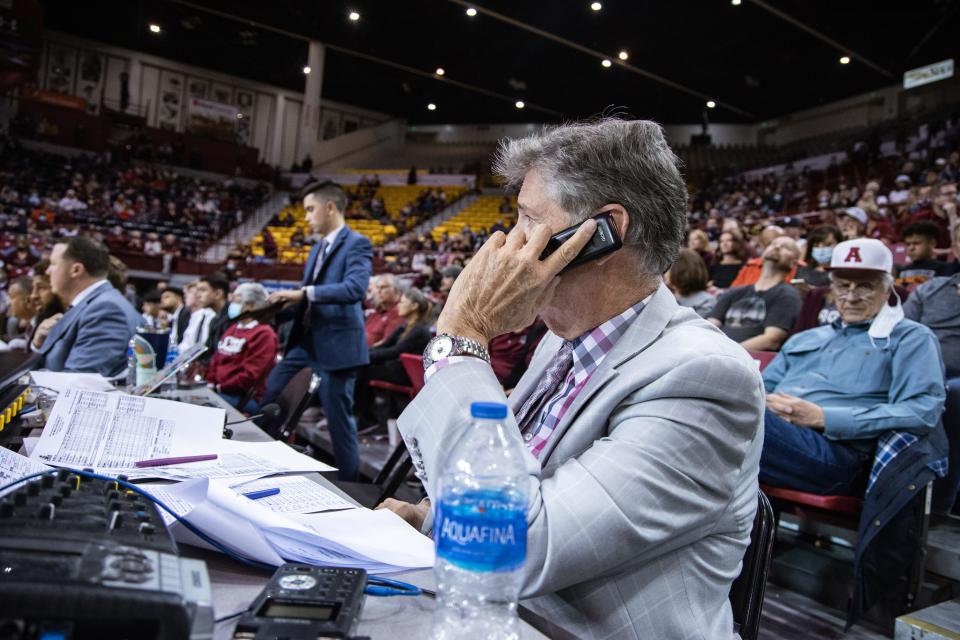 Jack Nixon is forced to do his radio show through his cell phone after the power went out on NMSU campus as the New Mexico State Aggies face off against the University of New Mexico Lobos at the Pan American Center in Las Cruces on Tuesday, Nov. 30, 2021.