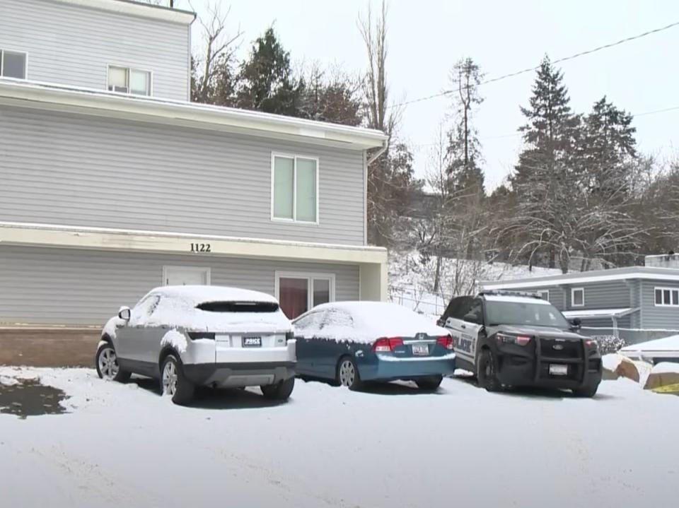 Two cars and a police vehicle sit outside the home where four University of Idaho students were murdered on 13 November. Police seized five cars from near the scene on 19 November (KTVB)