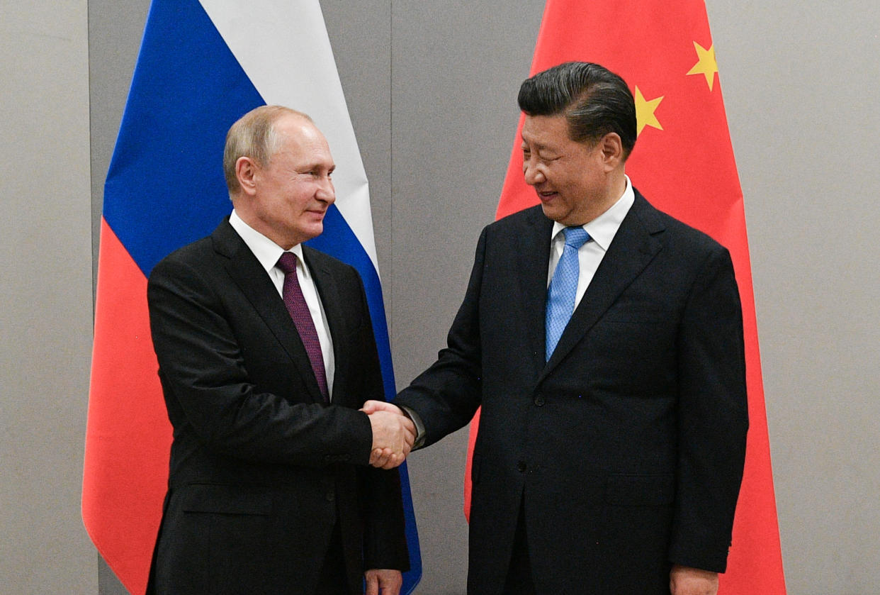 Russian President Vladimir Putin shakes hands with Chinese President Xi Jinping during their meeting on the sideline of the 11th edition of the BRICS Summit, in Brasilia, Brazil November 13, 2019. (Sputnik/Ramil Sitdikov/Kremlin via REUTERS)