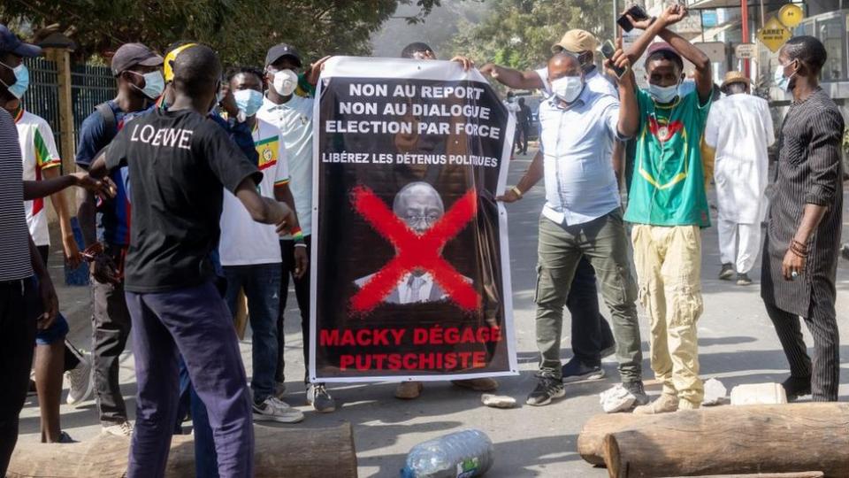 Protesters display a banner that reads "Macky, putschist, get out" during a demonstration in Dakar, Senegal - February 9, 2024