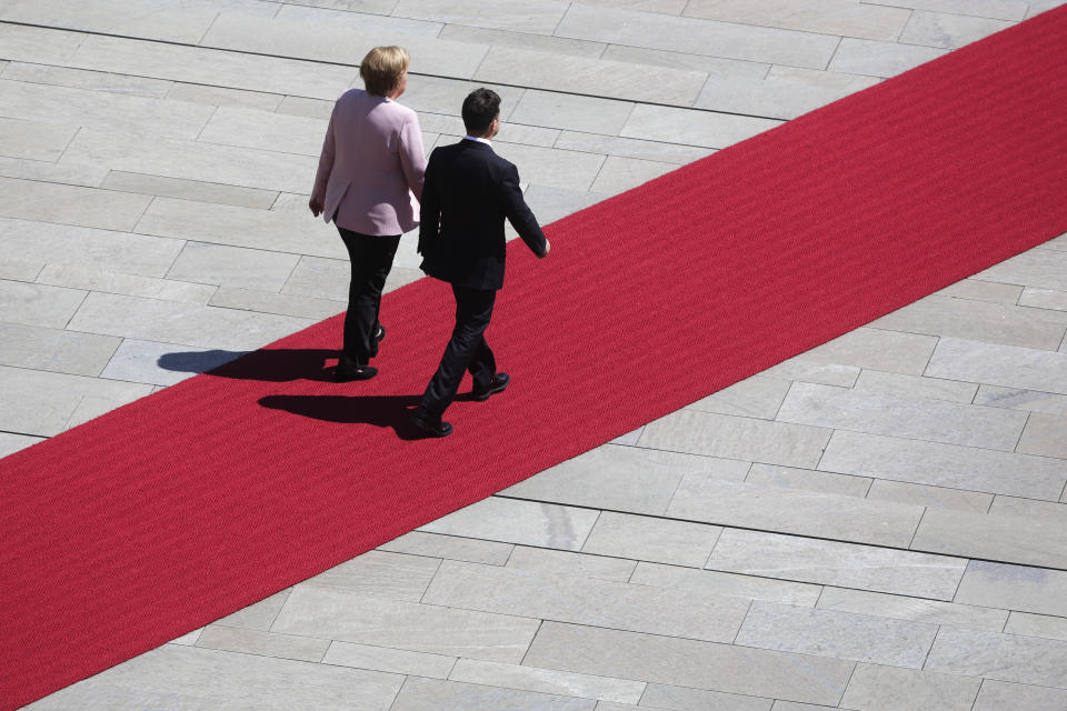 German Chancellor Angela Merkel, left, welcomes Ukrainian President Volodymyr Zelenskiy, right, for a meeting at the chancellery in Berlin, Germany, Tuesday, June 18, 2019. (AP Photo/Markus Schreiber)