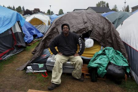 Aaron Ervin, 50, poses in front of his tent at SHARE/WHEEL Tent City 3 outside Seattle, Washington October 8, 2015. REUTERS/Shannon Stapleton