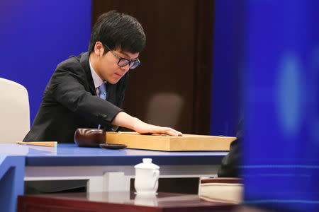 Chinese Go player Ke Jie puts a stone against Google's artificial intelligence program AlphaGo during their first match at the Future of Go Summit in Wuzhen, Zhejiang province, China May 23, 2017. REUTERS/Stringer
