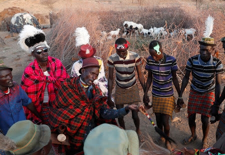 Turkana tribesmen dance around a killed bull during a wedding ceremony near Todonyang, Kenya March 22, 2019. REUTERS/Goran Tomasevic