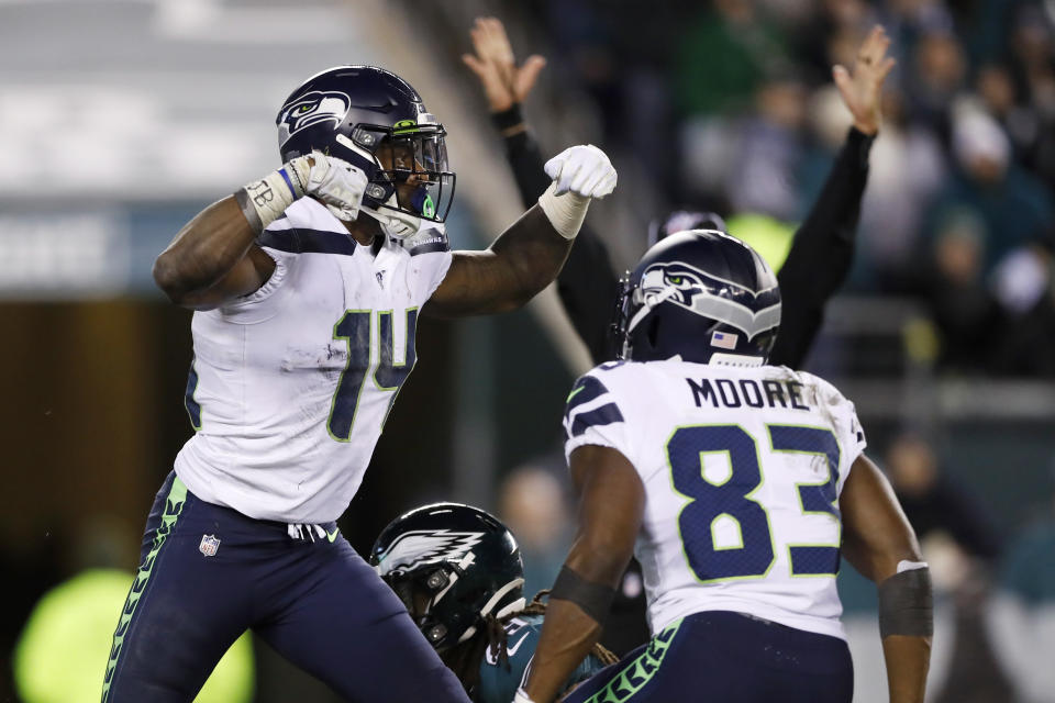 Seattle Seahawks' D.K. Metcalf, left, and David Moore celebrate after Metcalf's touchdown catch during the second half of an NFL wild-card playoff football game against the Philadelphia Eagles, Sunday, Jan. 5, 2020, in Philadelphia. (AP Photo/Julio Cortez)