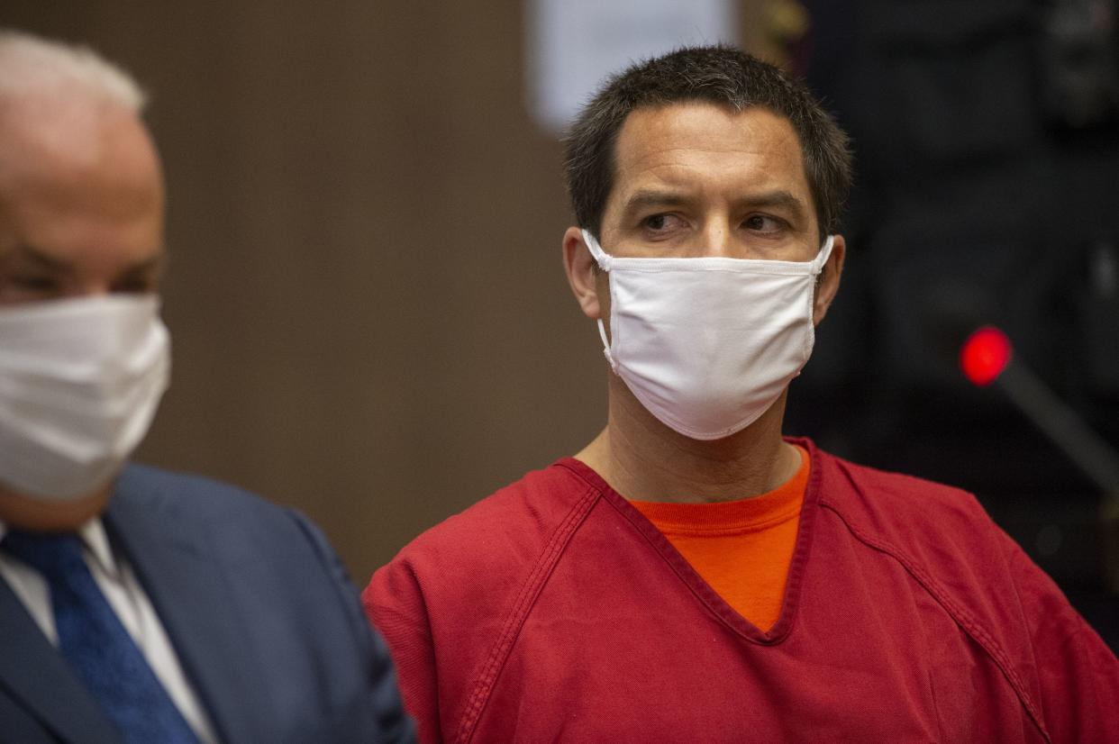 Scott Peterson listens to Stanislaus County Deputy District attorney Dave Harris speak during a hearing at the San Mateo County Superior Court in Redwood City, Calif., on Wednesday.