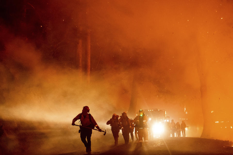 Firefighters battle the Mosquito Fire burning on Michigan Bluff Rd. in unincorporated Placer County, Calif., on Wednesday, Sept. 7, 2022. (AP Photo/Noah Berger)