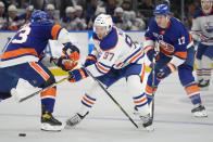 Edmonton Oilers center Connor McDavid (97) skates the puck up the ice against New York Islanders center Casey Cizikas (53) in the first period of an NHL hockey game Wednesday, Nov. 23, 2022, in Elmont, N.Y. (AP Photo/John Minchillo)