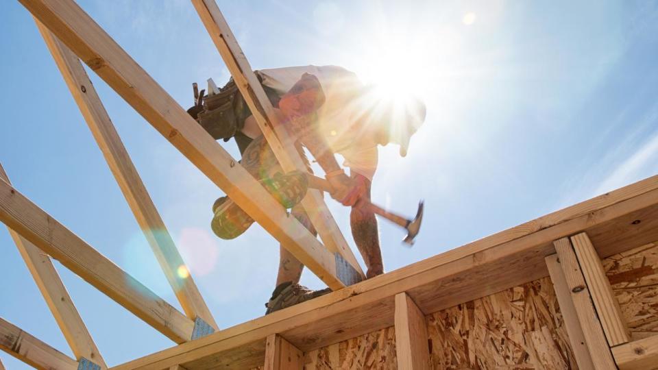 Construction Worker Framing A Building