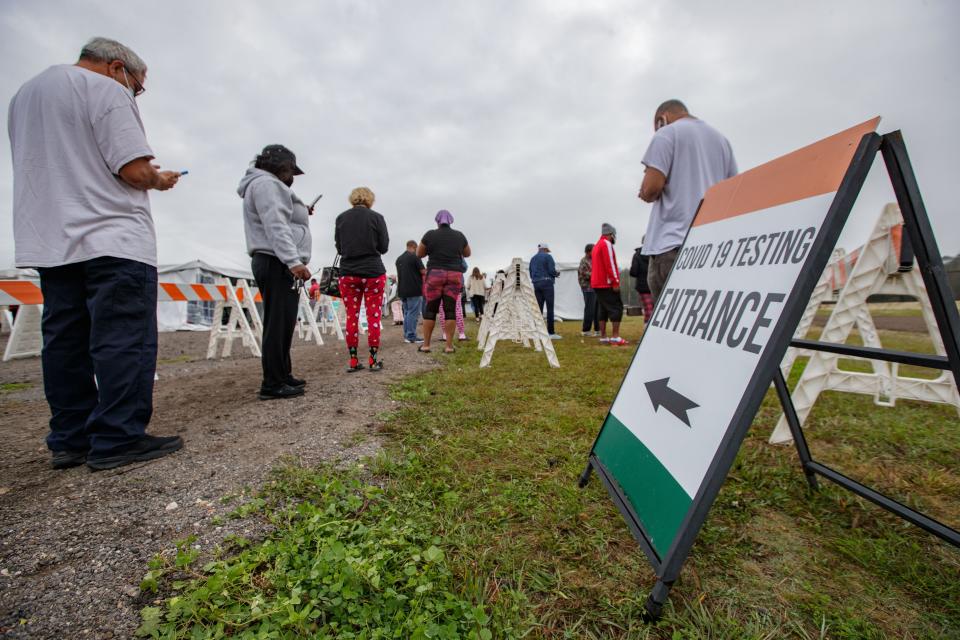 People wait in line to get tested for COVID-19 at the FAMU testing site Monday, Dec. 27, 2021.