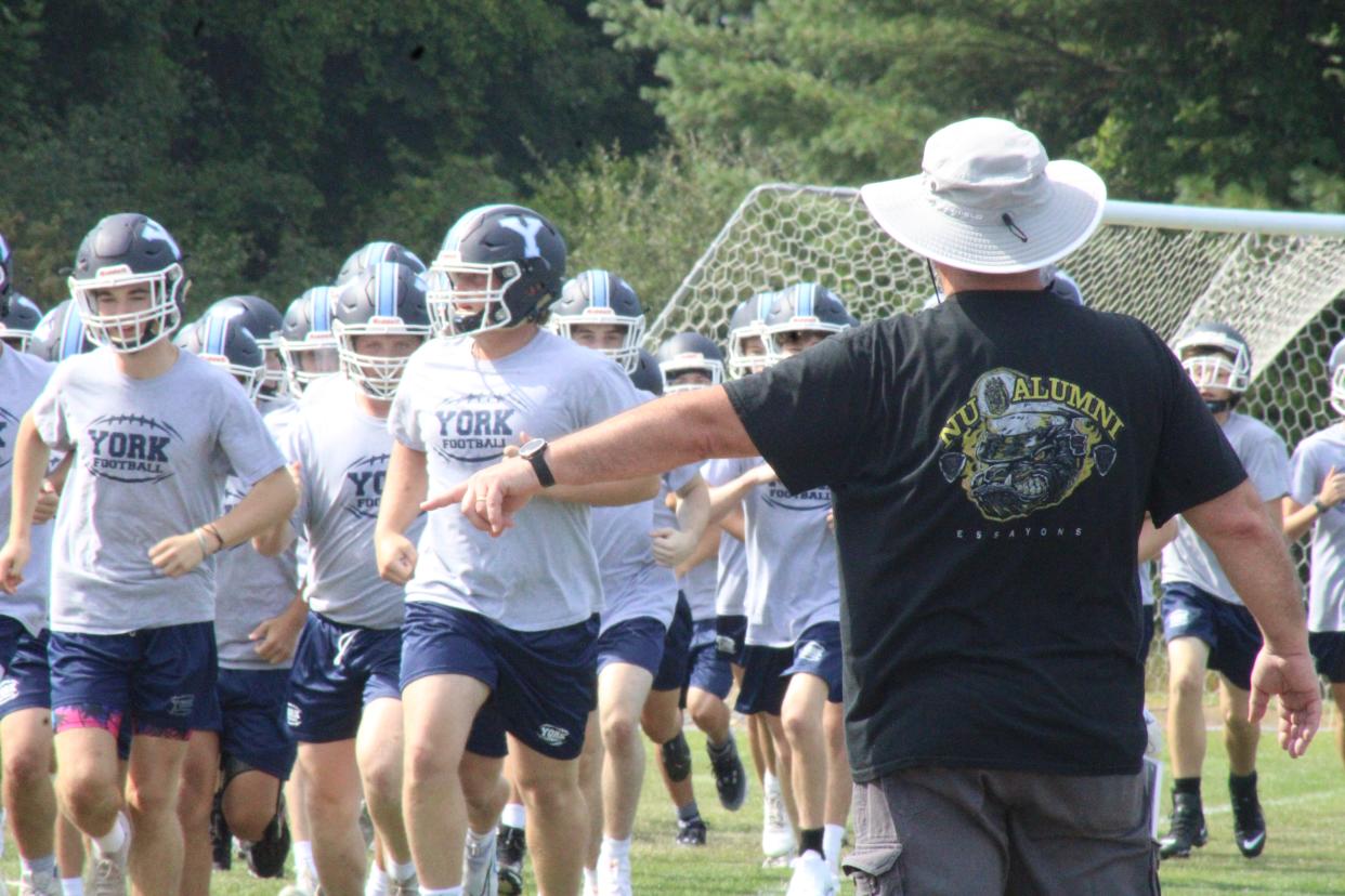 York High School head football coach Matt Nelson directs players during  a drill during Monday's first day of football practice. The Wildcats open their Class C South schedule on Friday, September 2 at Leavitt.