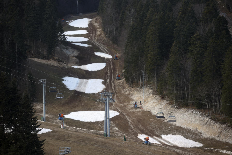 FILE - General view over the ski track with only a few patches of snow on Bjelasnica mountain near Sarajevo, Bosnia, Wednesday, Jan. 4, 2023. (AP Photo/Armin Durgut, File)