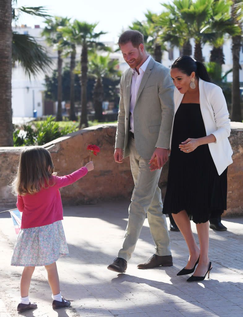 <p>The Sussexs appear elated as they meet a young girl who offers them a flower during their walkabout in the Andalusian Gardens in Rabat. </p><p><strong>More: </strong><a href="https://www.townandcountrymag.com/style/fashion-trends/g3272/meghan-markle-preppy-style/" rel="nofollow noopener" target="_blank" data-ylk="slk:Meghan Markle's Style Evolution;elm:context_link;itc:0;sec:content-canvas" class="link ">Meghan Markle's Style Evolution</a></p>