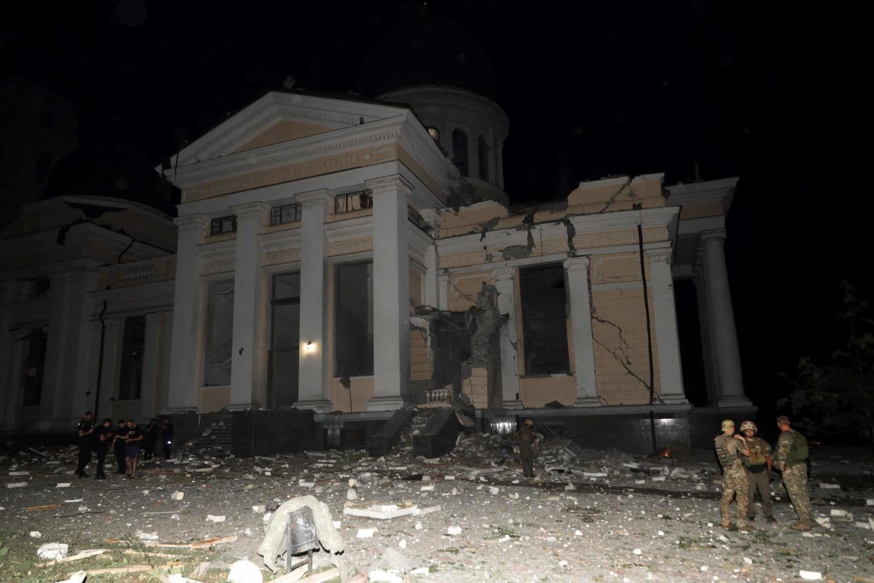 Ukrainian servicemen stand outside the Transfiguration Cathedral damaged as a result of a missile strike in Odesa (AFP via Getty Images)