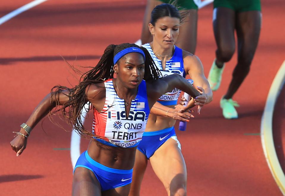 USA's Jenna Prandini, right, wasn't taking any chances with the handoff to Twanisha Terry, left, on the way to the win in heat 2 of the  4x100 meter relay during day eight of the World Athletics Championships at Hayward Field in Eugene, Oregon Friday July 22, 2022. 