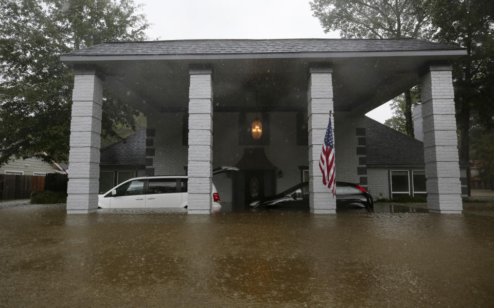 A home in the Lochshire neighborhood is flooded after the Luce Bayou overflowed during Tropical Storm Imelda Friday, Sept. 20, 2019, in Huffman, Texas. Emergency workers used boats Friday to rescue about 60 residents of a Houston-area community still trapped in their homes by floodwaters following one of the wettest tropical cyclones in U.S. history. (Godofredo A. Vásquez/Houston Chronicle via AP)