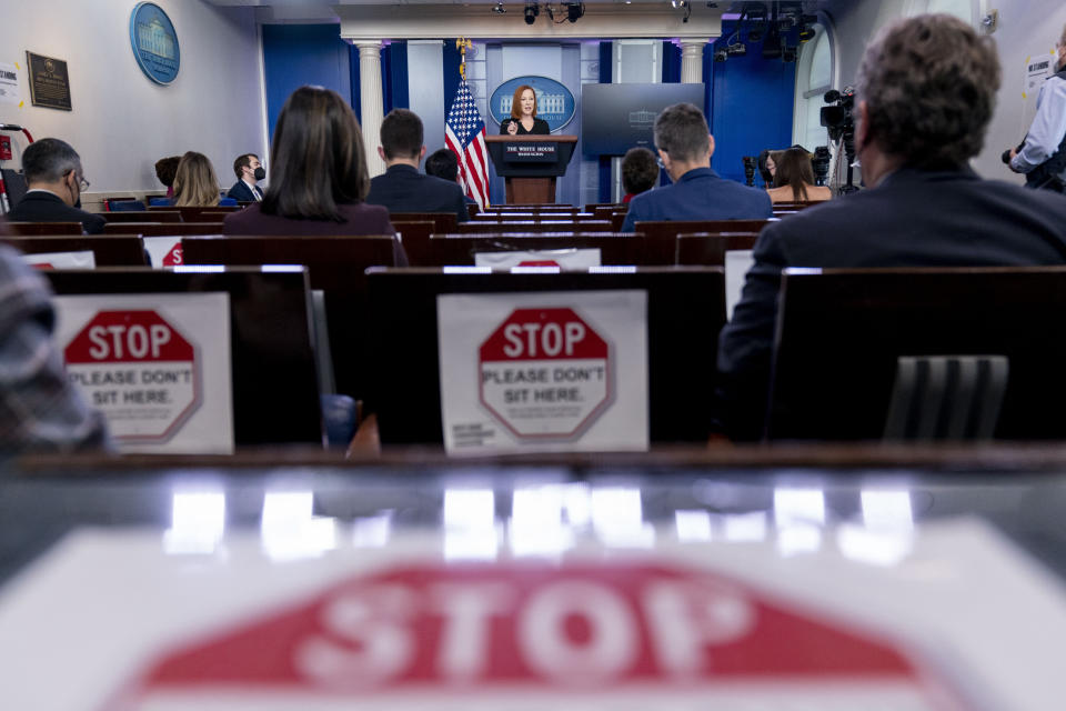 FILE - Signs restricting the number of reporters as part of increased COVID-19 restrictions are posted as White House press secretary Jen Psaki speaks at a press briefing at the White House in Washington, Jan. 4, 2022. Psaki, whose last day on the job is Friday, has answered reporters' questions nearly every weekday of the almost 500 days that Biden has been in office. That makes her a top White House communicator and perhaps the administration's most public face, behind only the president and Vice President Kamala Harris. (AP Photo/Andrew Harnik, File)