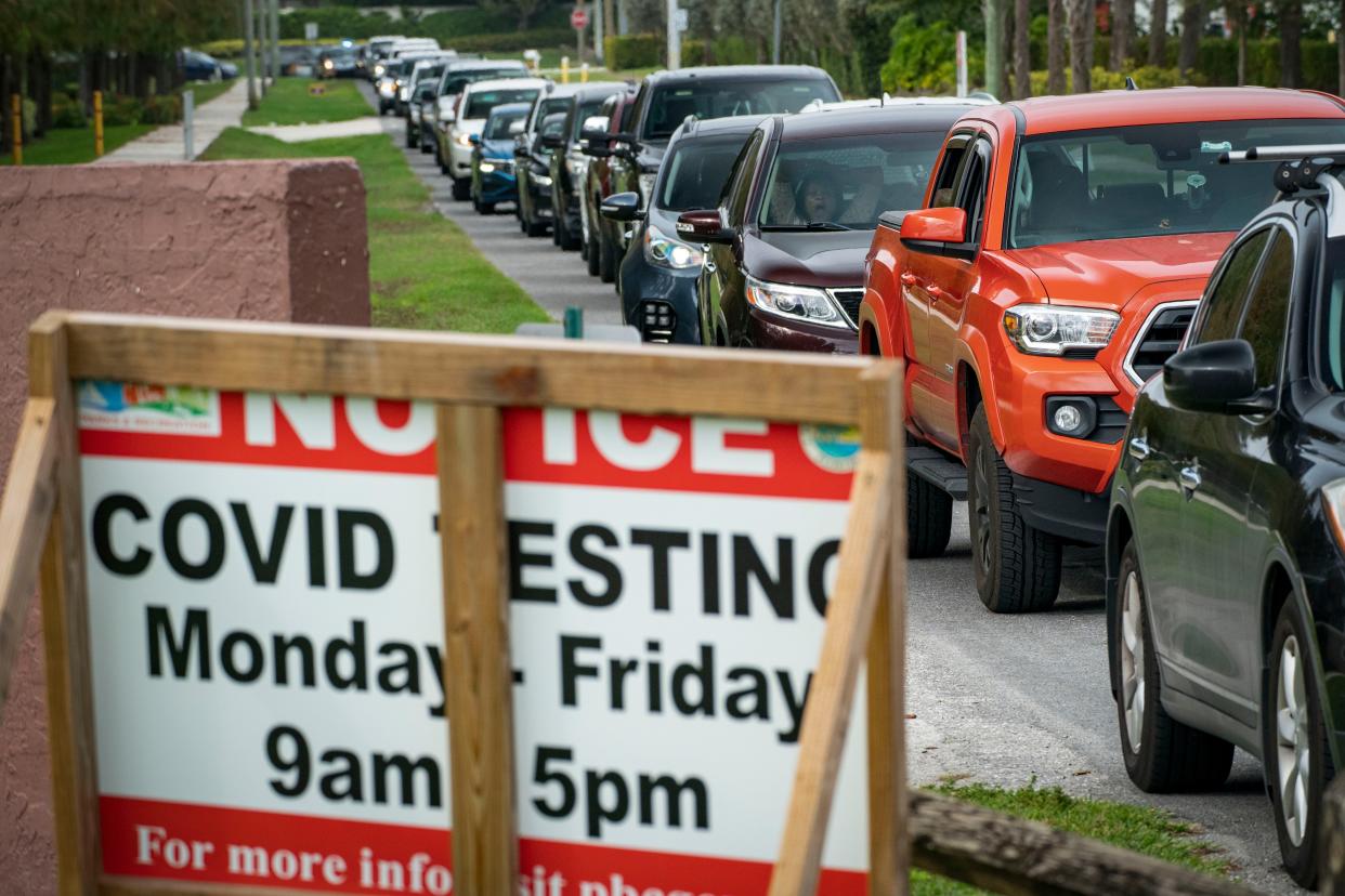 People line up for COVID-19 testing at a county-run drive-thru site at Caloosa Park in Boynton Beach in January.
